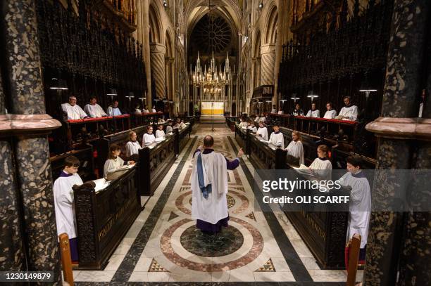 Daniel Cook , Master of the Choristers and Organist at Durham Cathedral, conducts the members of the cathedral choir as they practice before...