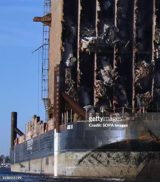 Crushed cars are seen in the bow section of the Golden Ray cargo ship after it was cut from the car carrier and towed away. A salvage company is...
