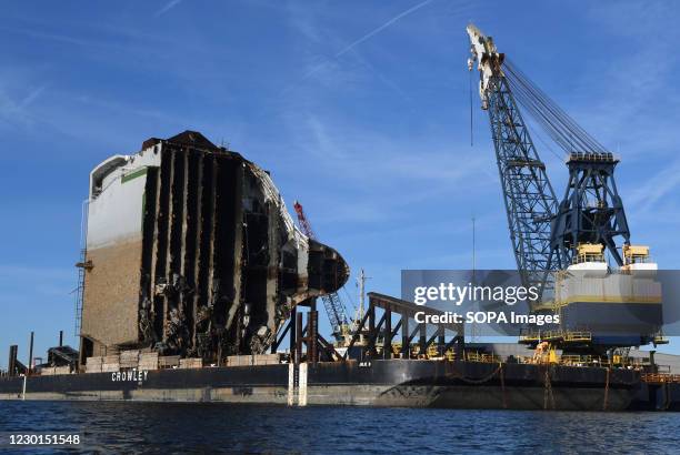 The bow section of the Golden Ray cargo ship sits on a barge after being cut from the car carrier and towed away. A salvage company is cutting the...