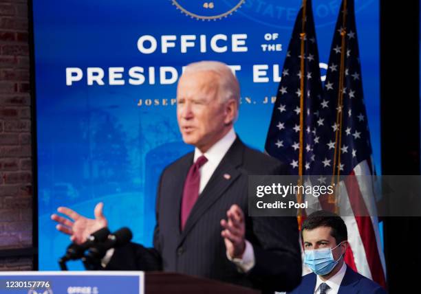 Former Democratic presidential candidate Pete Buttigieg listens as U.S. President-elect Joe Biden announces his nomination during a news conference...
