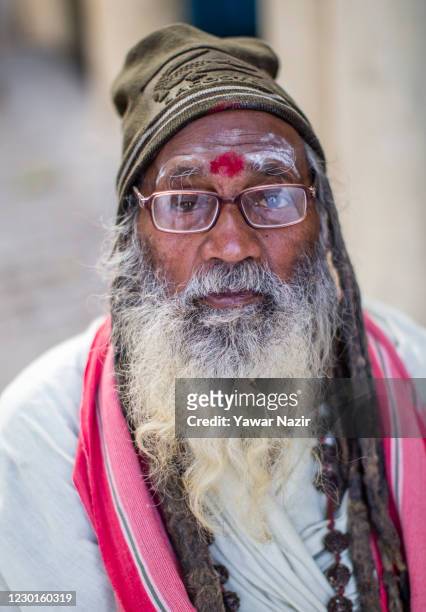 An elderly Indian man rests on a chair on the bank of Yamuna river on December 16, 2020 in Delhi, India. With a population of over 29 million people,...