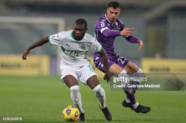 Lorenzo Venuti of ACF Fiorentina battles for the ball with Jeremie Boga of US Sassuolo during the Serie A match between ACF Fiorentina and US...