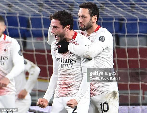Davide Calabria of AC Milan celebrates with Hakan Cahlanoglu after scoring a goal to 1-2 during the Serie A match between Genoa CFC and AC Milan at...