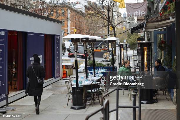 Customers sit in the outside dining area of a restaurant in New York, U.S., on Wednesday, Dec. 16, 2020. A major winter storm is zeroing in on more...