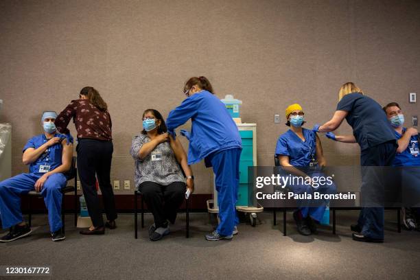 Healthcare workers get the Pfizer-BioNTech COVID-19 vaccination at the Legacy Emanuel Medical Center on December 16, 2020 in Portland, Oregon. Today...