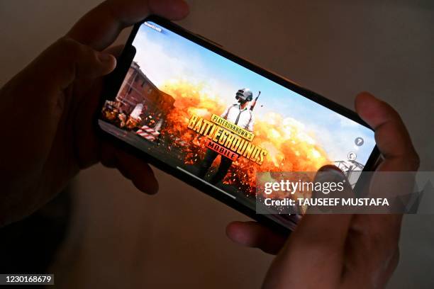 In this photo illustration taken on November 20 Zeyan Shafiq prepares to play the PUBG mobile game in Srinagar. - When India banned the hit PUBG...