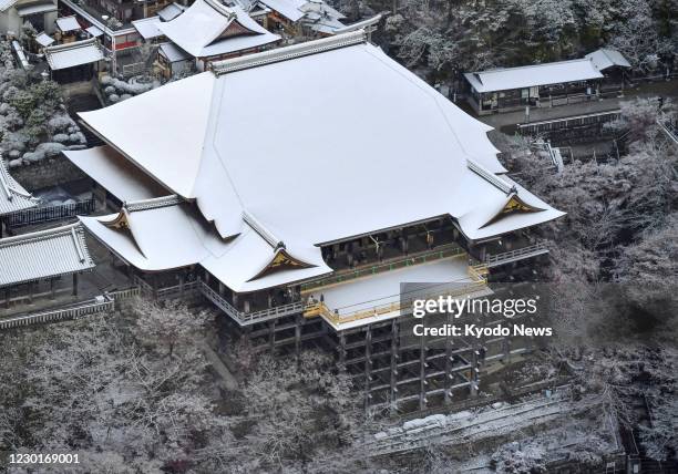 Photo taken Dec. 17 from a Kyodo News helicopter shows Kiyomizu temple in Kyoto, Japan, covered with snow for the first time this winter.