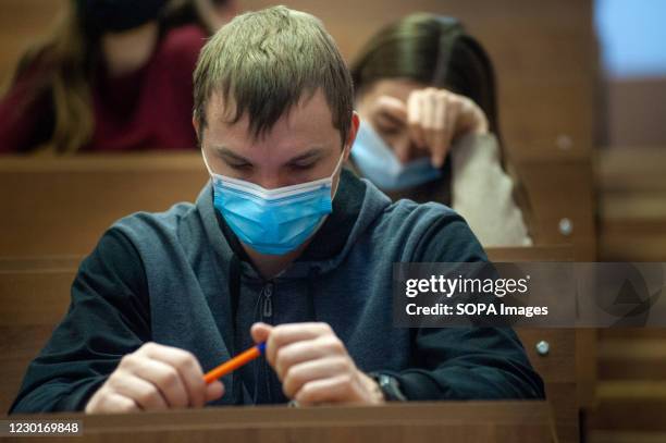 Student wearing a face mask sits in a classroom at the Tambov state university. In Russia, due to the coronavirus pandemic, many universities have...