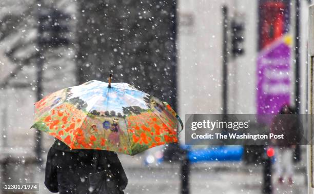 Travelers come and outside of Union Station as the Washington area saw a messy mix of snow, sleet, freezing rain.