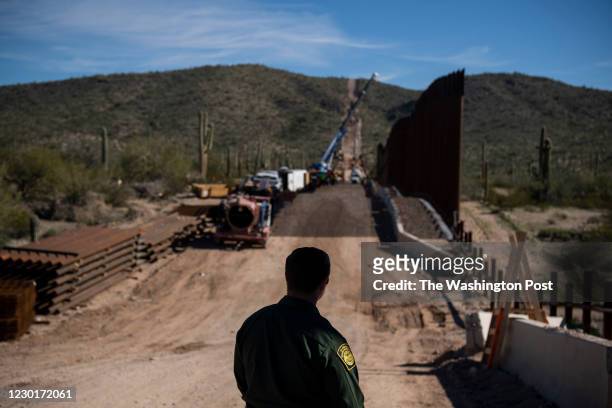 Border Patrol Agent Joe Curran looks at the border fence construction in the Organ Pipe Cactus National Monument in Lukeville, AZ on January 7, 2020.