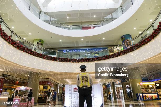 Security officer stands at the SM Pampanga mall in Manila, the Philippines, on Thursday, Dec. 17, 2020. The Philippine government lowered its outlook...