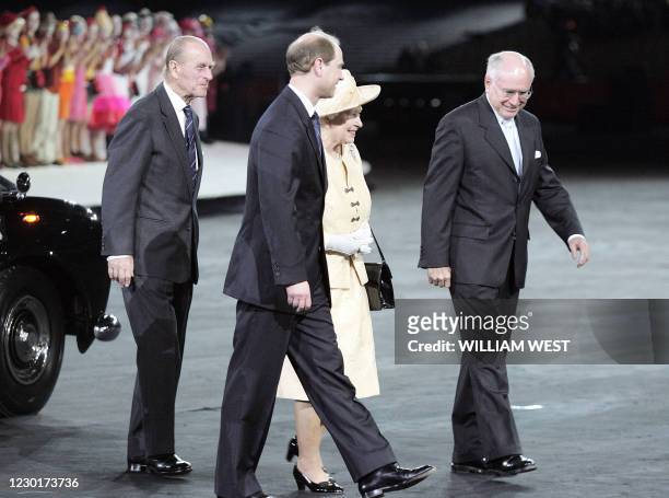 Australian Prime Minister John Howard escorts Britain's Queen Elizabeth , Prince Philip and Prince Edward upon her arrival at the opening ceremony...