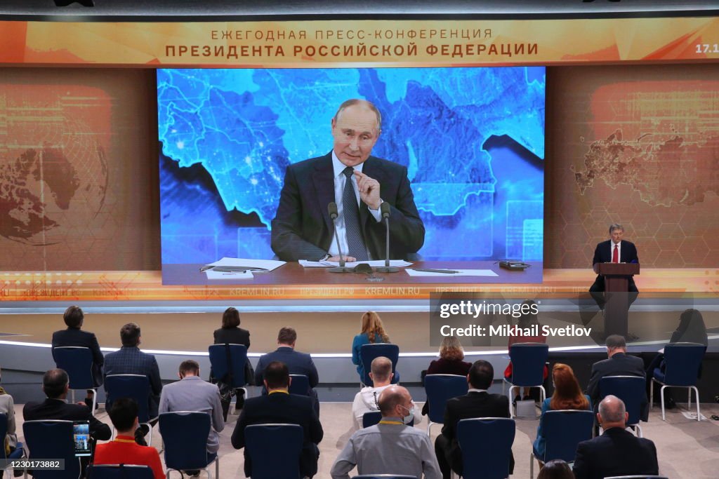Russian President Vladimir Putin seen speaking on the screen during ...