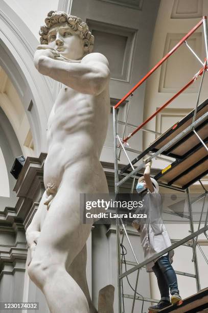 Restorer cleans Michelangelo's David statue while preparing for the reopening of the Galleria dell'Accademia which was closed for almost three months...