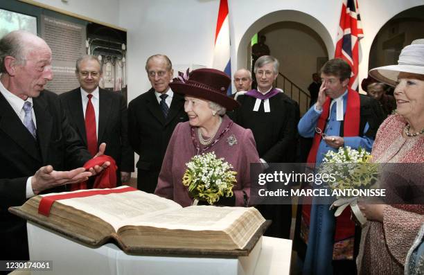 Queen Elizabeth II smiles as she is shown the first bible donated to the English society in Amsterdam by L. Wagenaar 05 February 2007 at the...