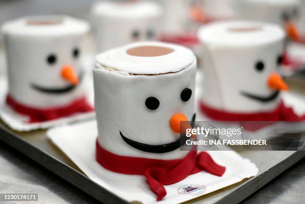 Cakes featuring a toilet roll as snowman are displayed at a bakery in Dortmund, western Germany, on December 17, 2020 during the partial lockdown to...