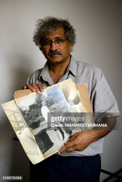 India-history-photography-Gandhi" FEATURE by Neha Lall In this August 10, 2010 photograph, Indian photographer Aditya Arya poses with his book...