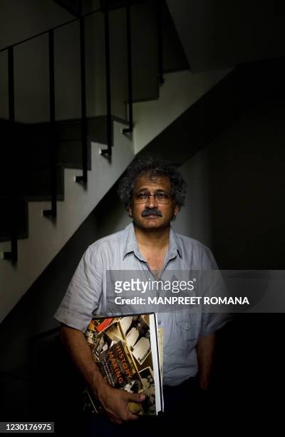 India-history-photography-Gandhi" FEATURE by Neha Lall In this August 10, 2010 photograph, Indian photographer Aditya Arya poses with his book...