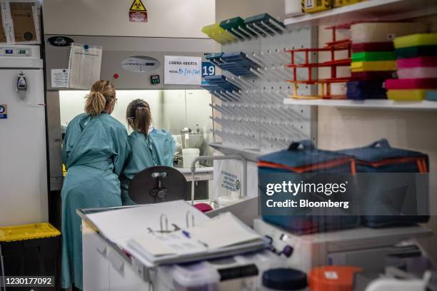 Medical workers prepare materials at a fume cabinet in the laboratory during a phase 3 trial of the Johnson & Johnson Covid-19 vaccine by the Germans...