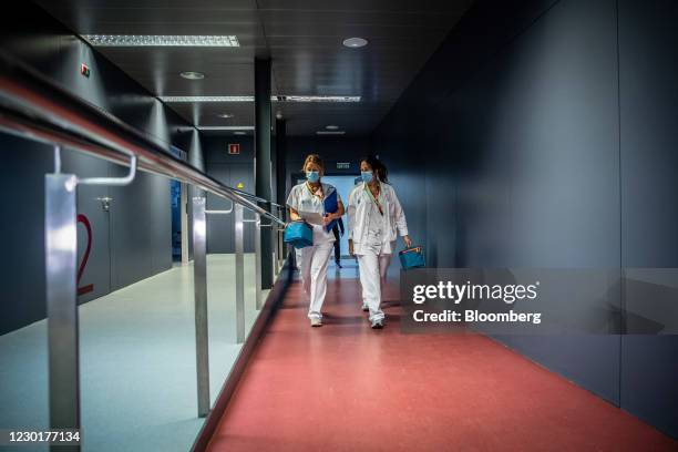 Medical workers carry cold storage boxes containing injection material to the administration room during a phase 3 trial of the Johnson & Johnson...