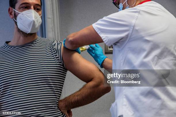 Medical worker administers an injection to a volunteer during a phase 3 trial of the Johnson & Johnson Covid-19 vaccine by the Germans Trias i Pujol...