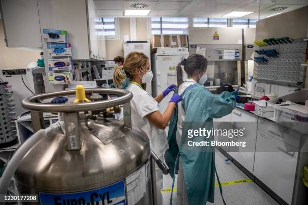 Medical workers dress in personal protective equipment inside a laboratory during a phase 3 trial of the Johnson & Johnson Covid-19 vaccine by the...