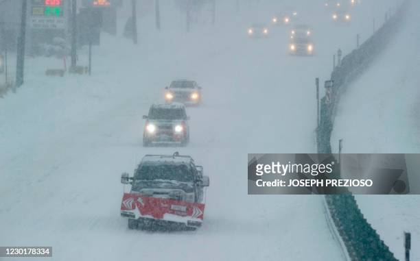 Cars drive in limited visibility on US Route 1, in Saugus, Massachusetts on December 17, 2020. - A major snowstorm hit the US east coast during...