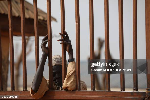 Parent waits outside the Government Science Secondary school in Kankara, in northwestern Katsina State, Nigeria on December 16, 2020. - Boko Haram on...