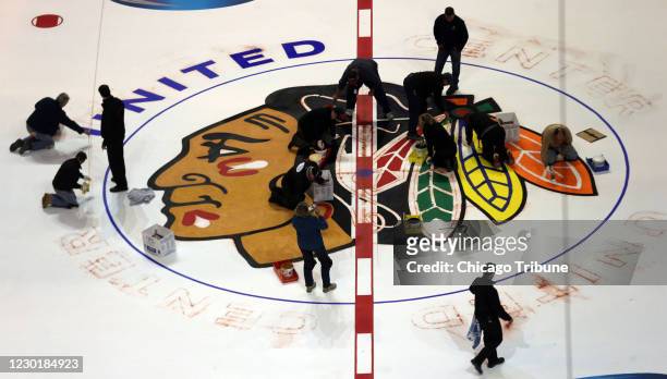 Nearly painted and completed, the Chicago Blackhawks logo slowly appears on the ice. The Blackhawks won&apos;t follow the Cleveland Indians&apos;...