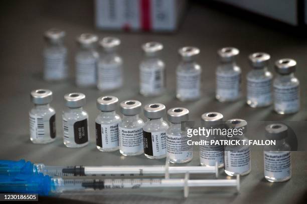 Syringes wand vials of the Pfizer-BioNTech Covid-19 vaccine are prepared to be administered to front-line health care workers under an emergency use...