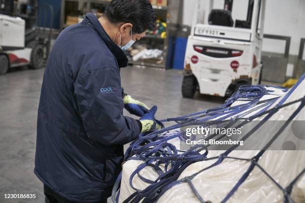 Workers packing a shipment at the SATS Ltd. Coolport handling center at Changi Airport in Singapore, on Wednesday, Dec. 16, 2020. SATS is preparing...