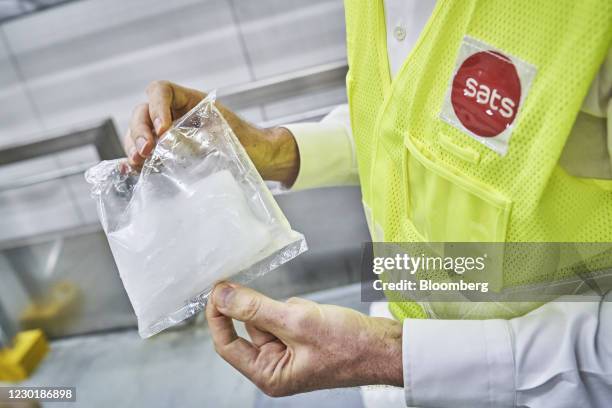 Dry ice to be used in an Envirotainer, a temperature-cooled container, is arranged at the SATS Ltd. Coolport handling center at Changi Airport in...