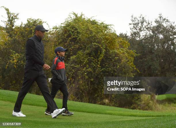 Tiger Woods and his 11-year-old son Charlie play the 10th hole during the pro-am round at the PNC Championship golf tournament at the Ritz-Carlton...