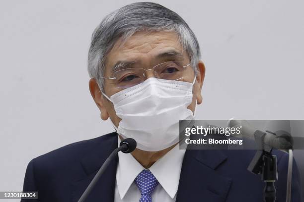 Haruhiko Kuroda, governor of the Bank of Japan , wears a protective mask as he attends a news conference at the central bank's headquarters in Tokyo,...