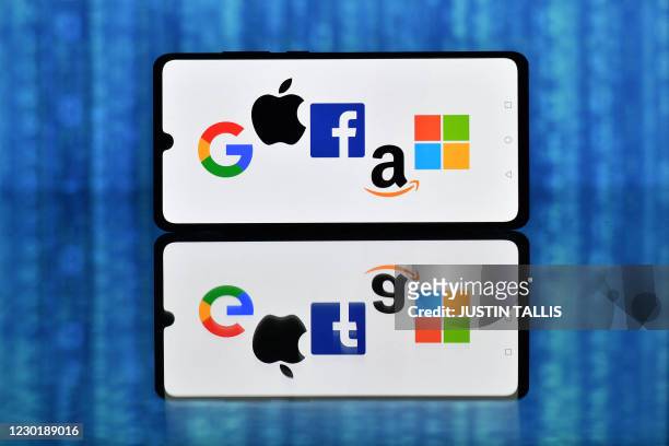 An illustration picture taken in London on December 18, 2020 shows the logos of Google, Apple, Facebook, Amazon and Microsoft displayed on a mobile...