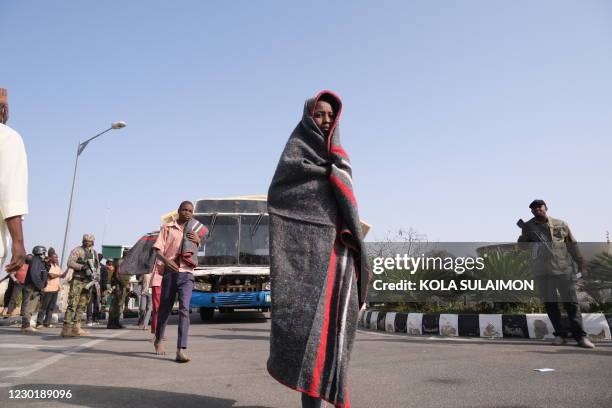 Released students from the Government Science Secondary school, in Kankara, in northwestern Katsina State, Nigeria are led into the Government House...