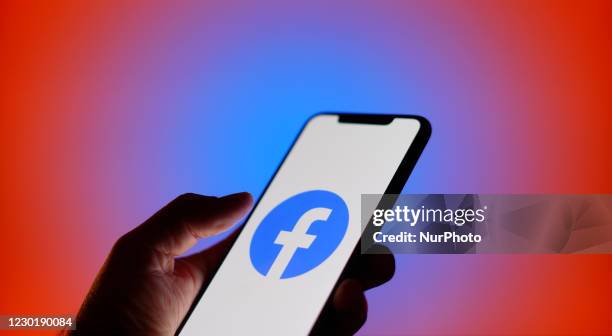 The Facebook logo is seen on an iPhone in this photo illustration in Warsaw, Poland on December 17, 2020. Facebook has disabled several features on...