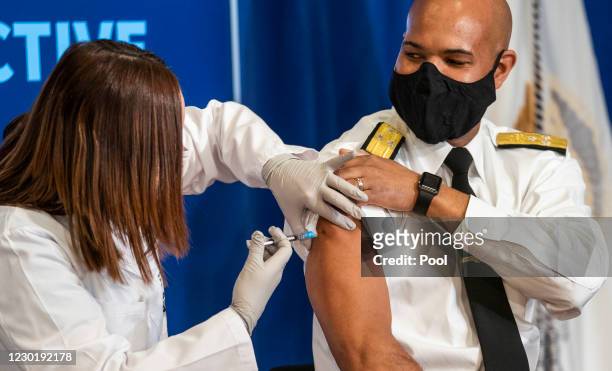 Surgeon General Jerome Adams receives a COVID-19 vaccine to promote the safety and efficacy of the vaccine at the White House on December 2020 in...