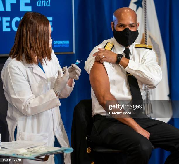 Surgeon General Jerome Adams receives a COVID-19 vaccine to promote the safety and efficacy of the vaccine at the White House on December 2020 in...