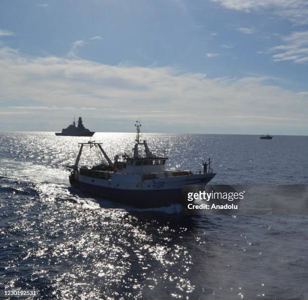 Two Italian boats accompanied by the Margottini frigate, are seen returning to their hometown of Mazara del Vallo in Sicily, on December 18, 2020. In...