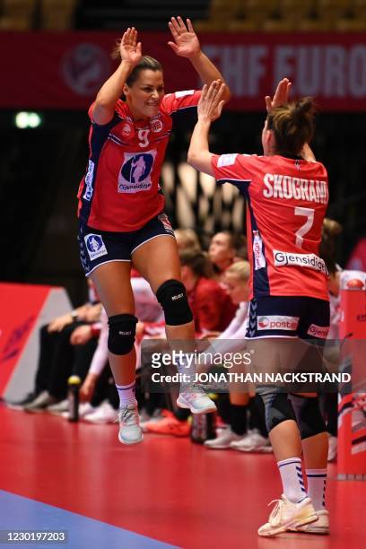 Norway's Right back Nora Mork celebrates after scoring with Norway's Right back Stine Skogrand during the semi-final match between Denmark and Norway...