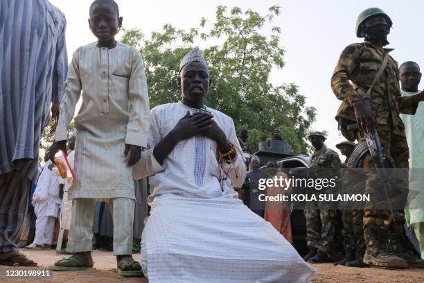 Man reacts as he reunites with his son who was among those who were kidnapped upon their release in Katsina, on December 18, 2020. - Exhausted and...