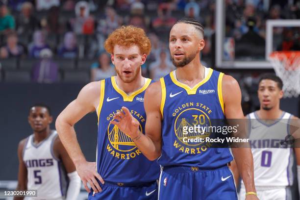 Nico Mannion and Stephen Curry of the Golden State Warriors talk during the game against the Sacramento Kings on December 15, 2020 at Golden 1 Center...