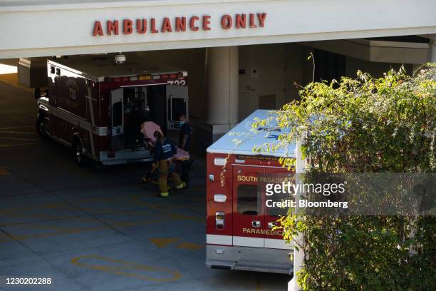 Paramedics wait at the ambulance entrance at Huntington Hospital in Pasadena, California, U.S., on Friday, Dec. 18, 2020. Greater Los Angeles is...