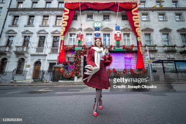 Member of the public poses outside Private members' club Annabel's which has brought The Nutcracker to life in its annual festive makeover as seen on...