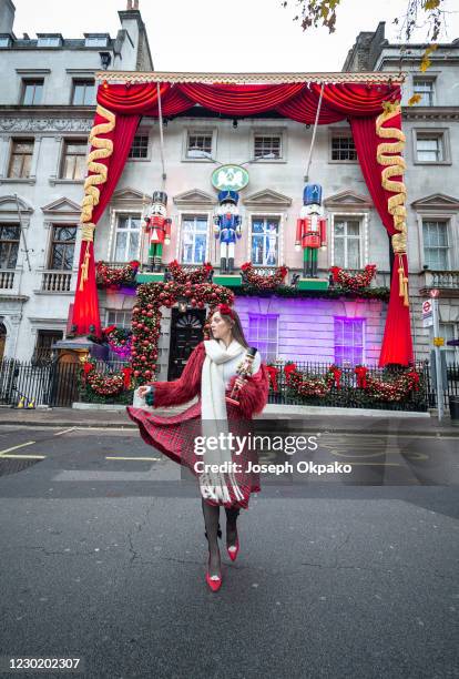 Member of the public poses outside Private members' club Annabel's which has brought The Nutcracker to life in its annual festive makeover as seen on...