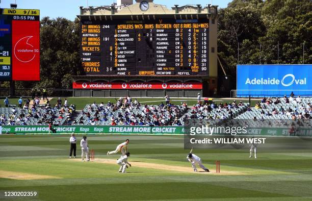 Australia's Pat Cummins fells India's Mohammed Shami with a bouncer as India is dismissed for only 36 runs on the third day of the first cricket Test...
