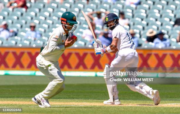 India Virat Kohli watches while Australia's Travis Head fields the ball as India is all out for only 36 runs on the third day of the first cricket...