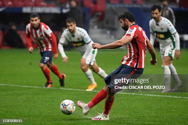Atletico Madrid's Spanish forward Diego Costa shoots a penalty kick and scores a goal during the Spanish league football match between Club Atletico...