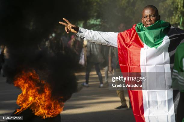 Sudanese demonstrations wearing face masks gather to protest against Sudanese government to mark the second anniversary of the start of a revolt that...